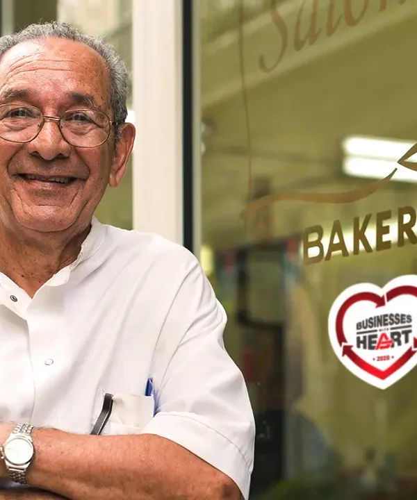 Man Standing In front of barkery shop with arms crossed