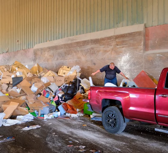 Athens Services DART Recycling and Transfer Station - Employee with Truck dumping trash